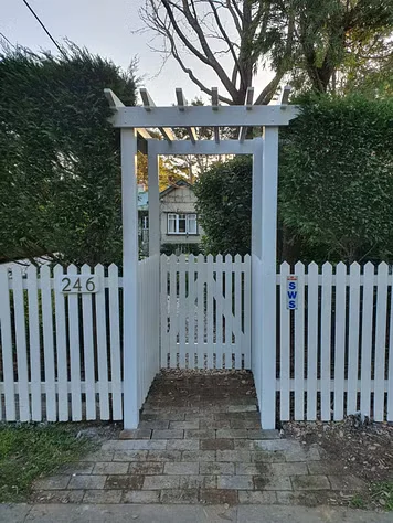 Garden Arbors surrounded by picket fence